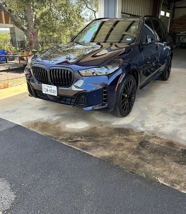 Dark blue BMW SUV with a deep, glossy exterior finish after a Texas Auto Club mobile detail