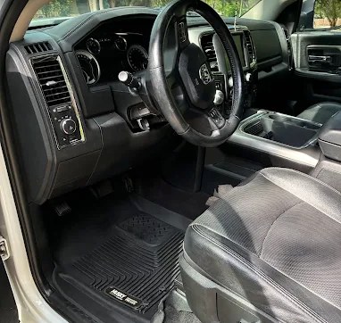 Clean black leather interior and dashboard of a Ram truck after a full interior detail