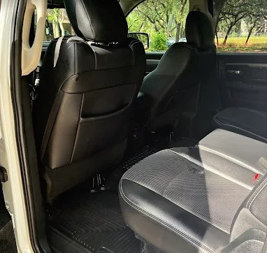 Spotless black leather rear bench seat after an interior detail
