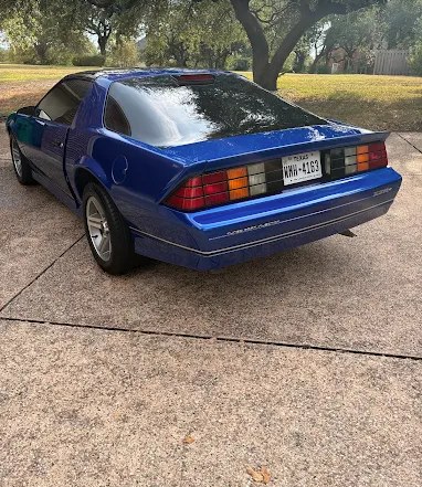Classic blue Chevrolet Camaro with a mirror-like paint finish after detailing