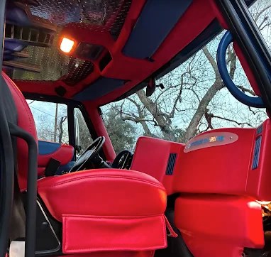 Custom red and blue leather interior of a show van after a full interior detail